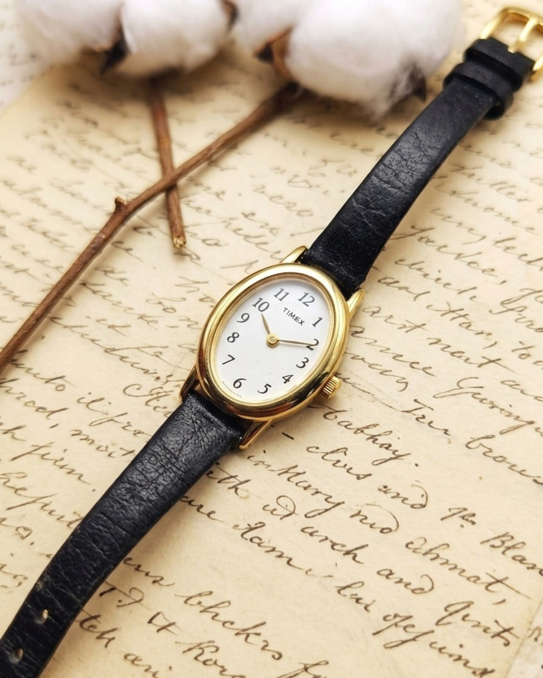 1990s Vintage Timex Oval Gold-Tone Dainty Watch – Black Leather Strap Edition