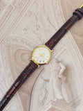 Vintage Timex Gold-Tone Ladies Petite Dress Watch – White Dial & Glossy Mahogany Leather Strap Edition